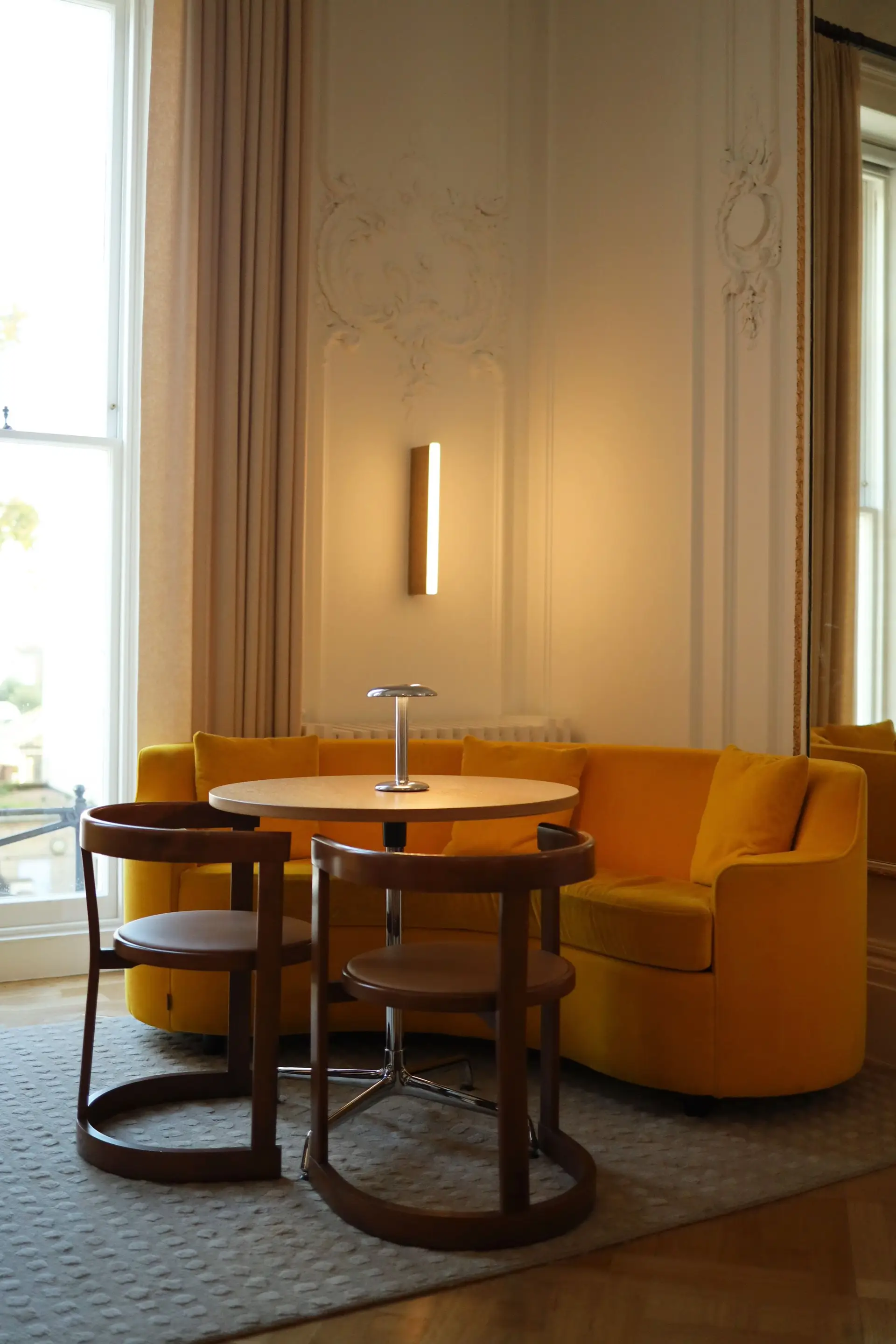 Elegantly illuminated salon with bespoke architectural details