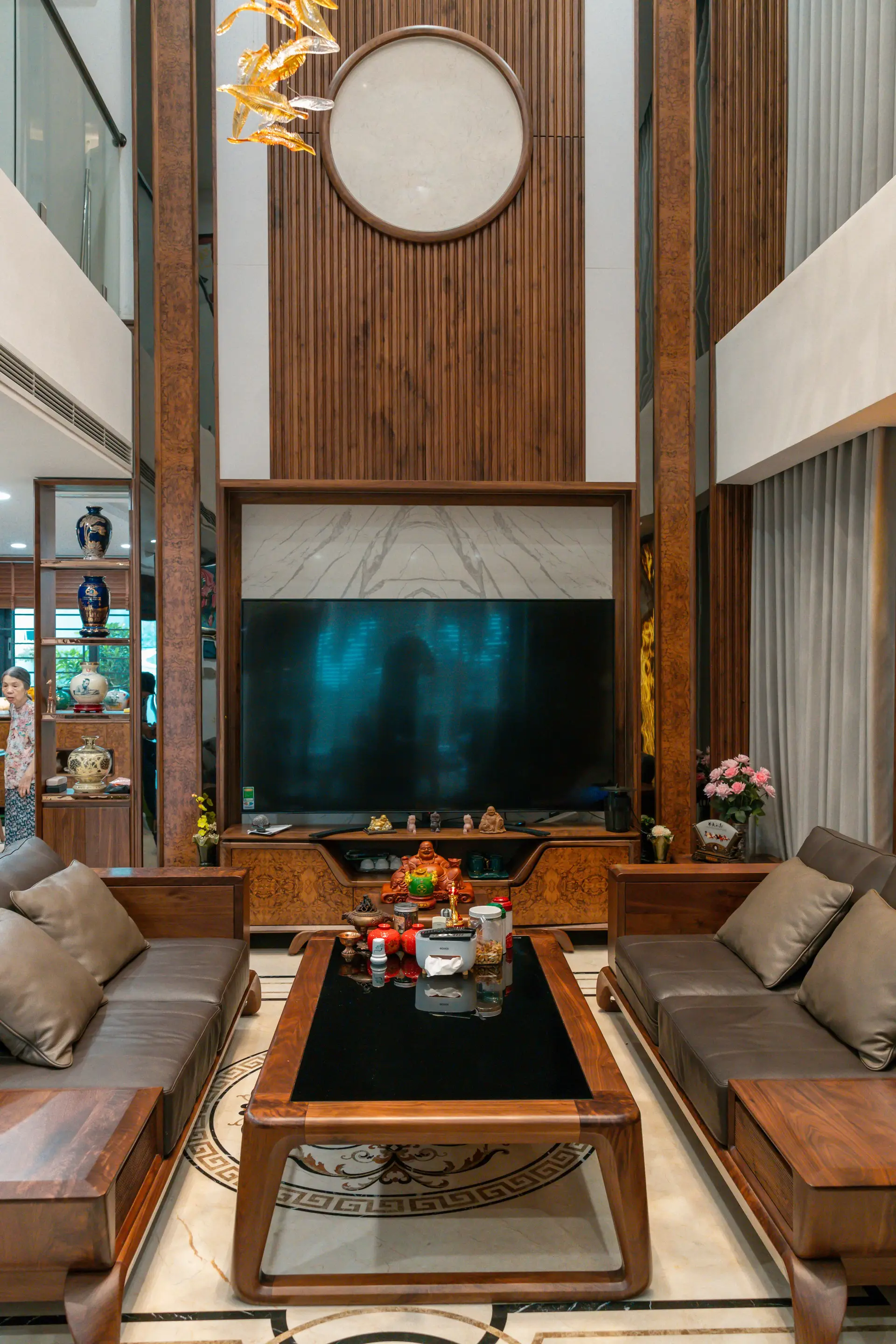 Expansive living salon with bespoke recessed architectural lighting and warm timber ceiling