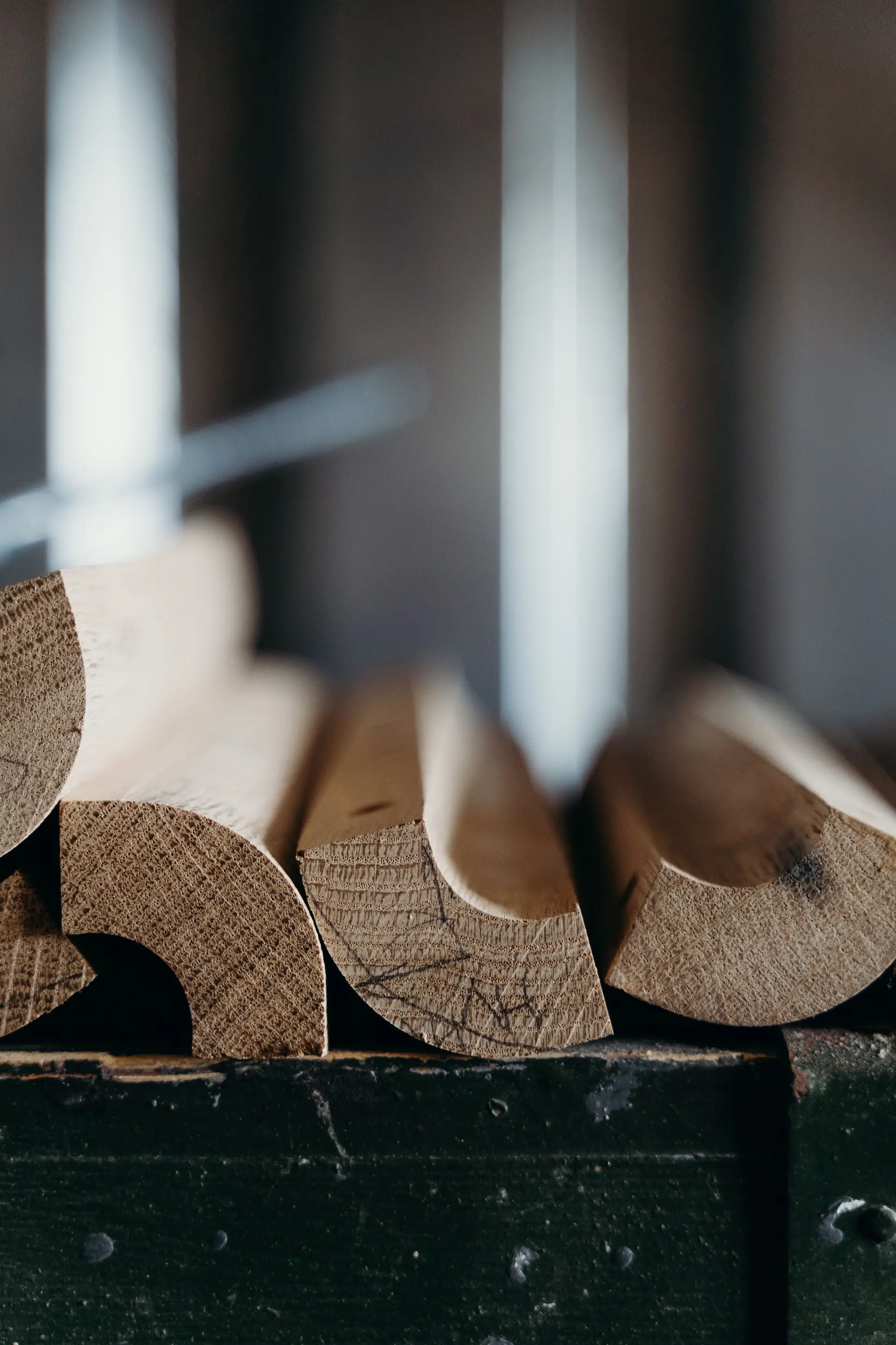 Stacked architectural wooden moldings showing intricate artisan joinery and grain
